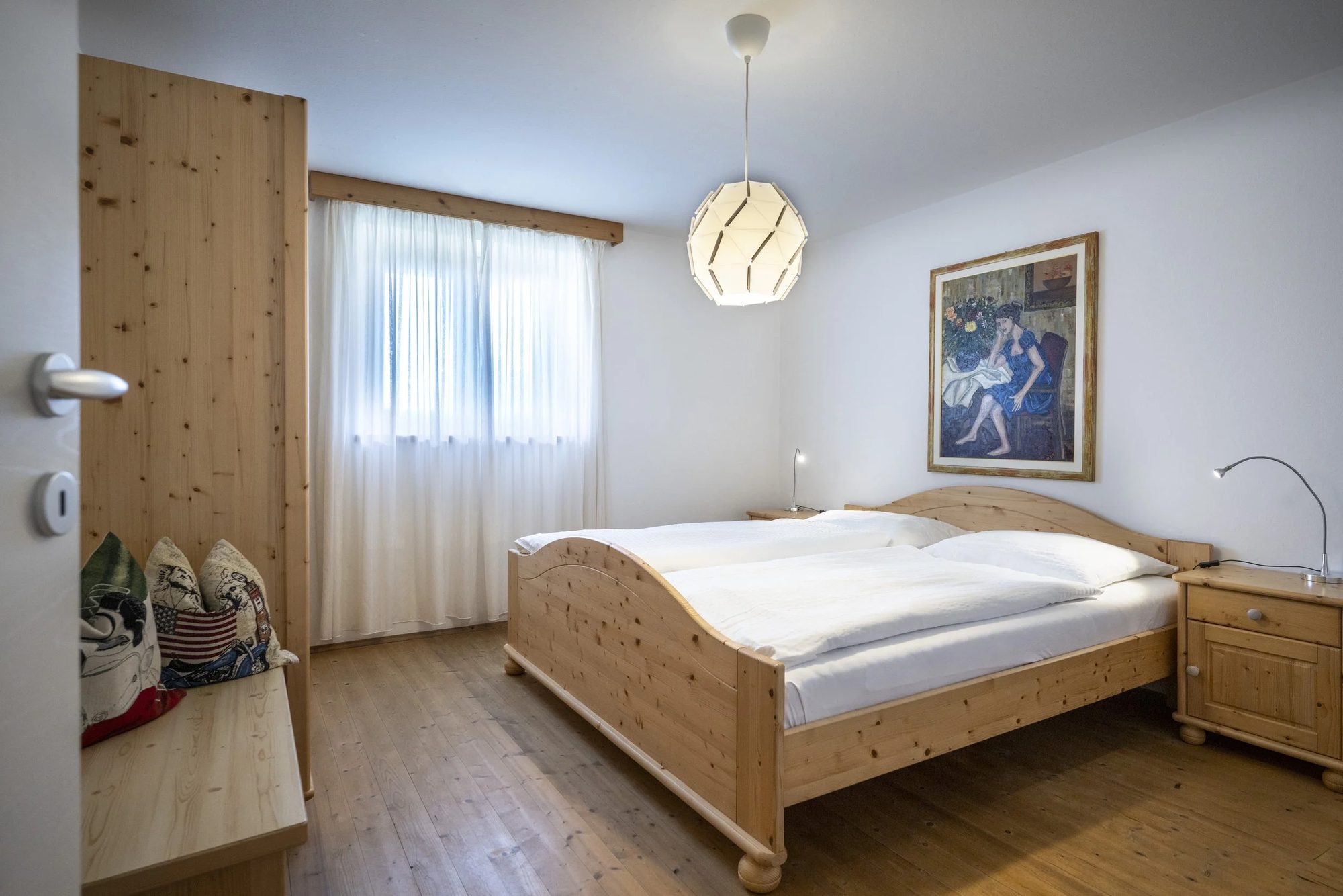 Bedroom with wooden bed frames and white bedding