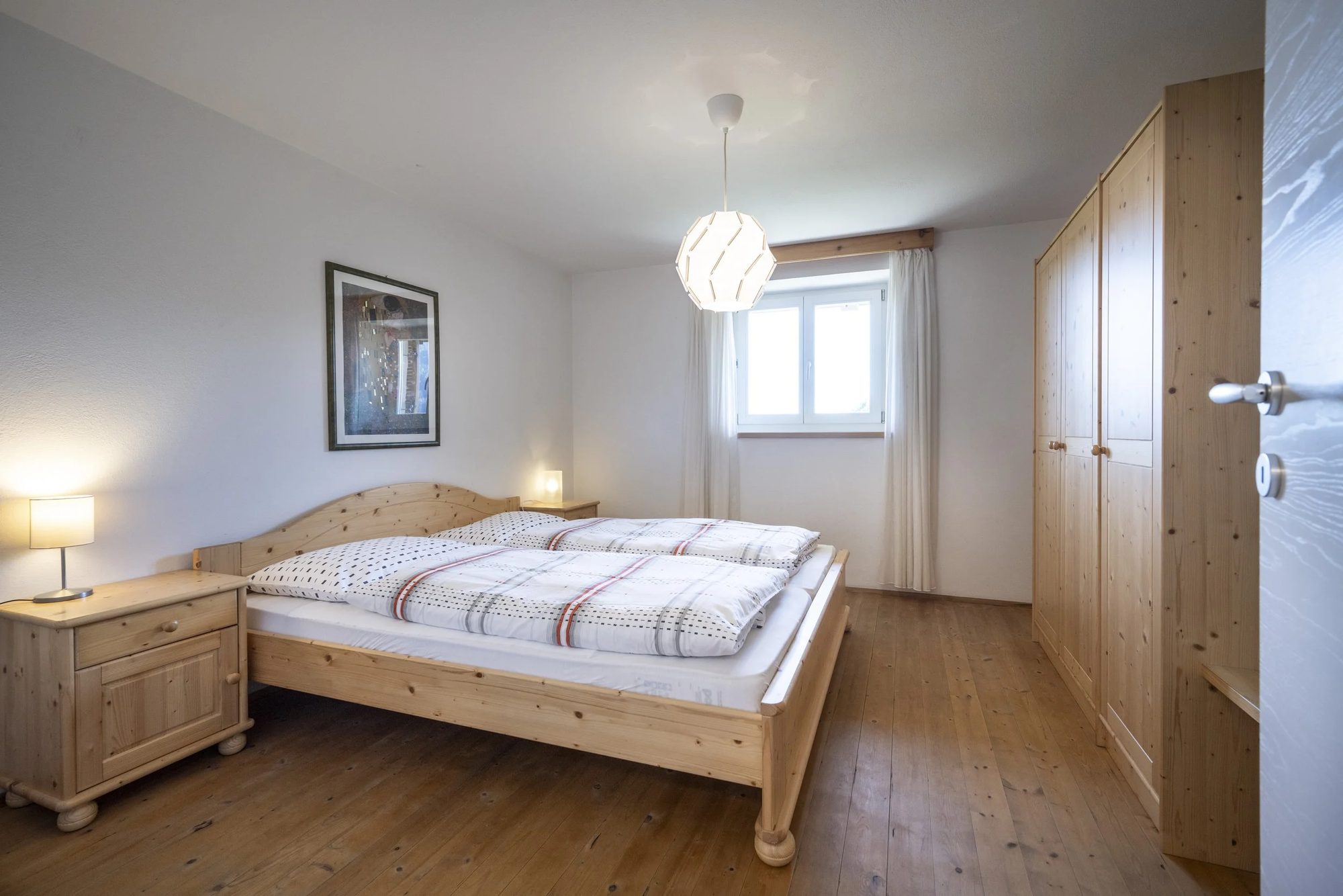 Bedroom with a wooden bed and bedside tables