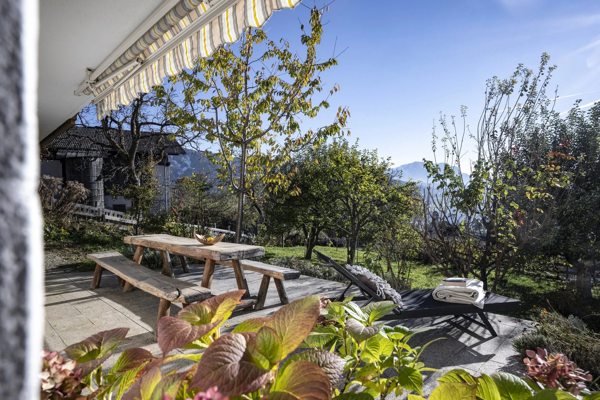 A sunny garden terrace with mountain views