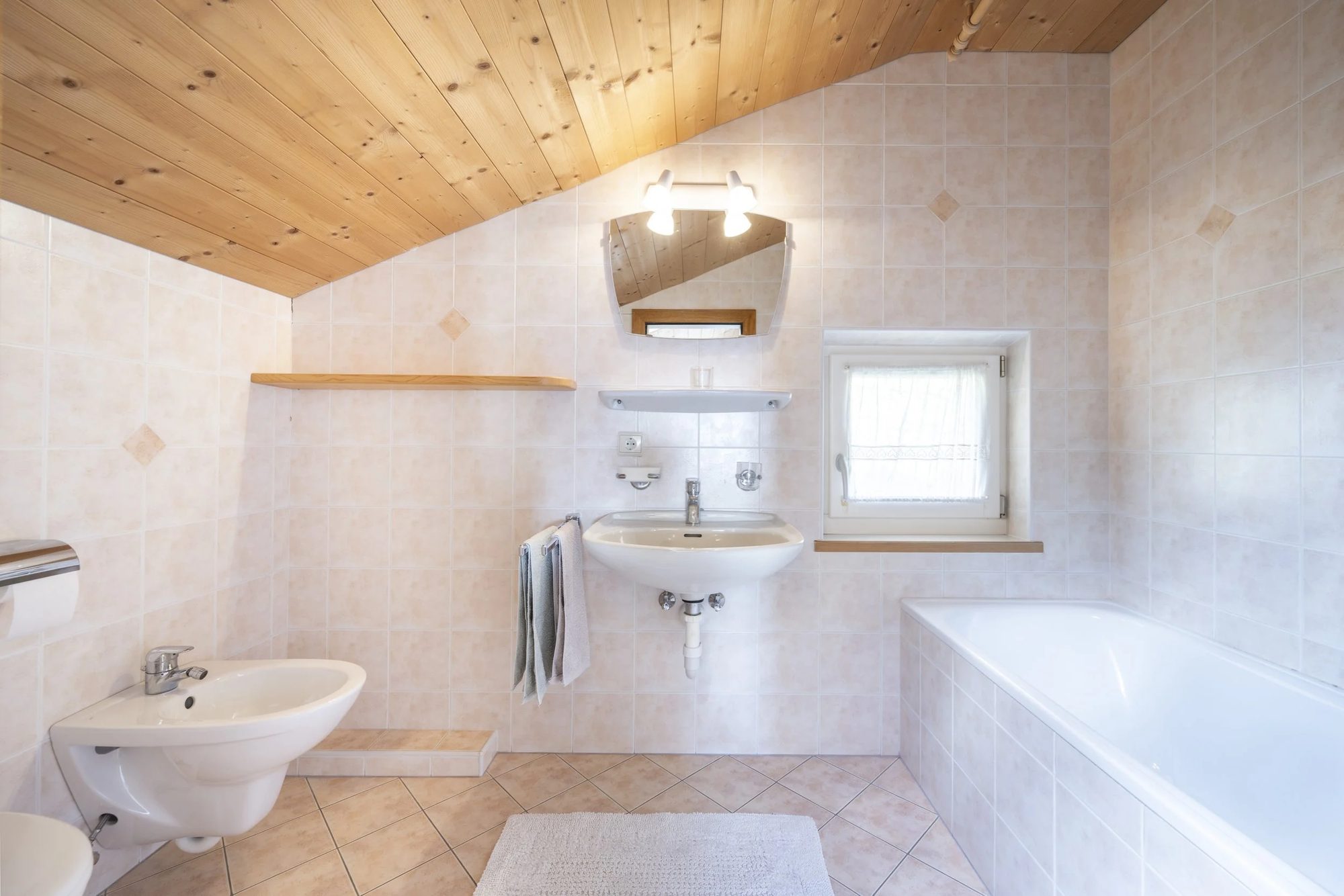 Bathroom with beige tiled walls