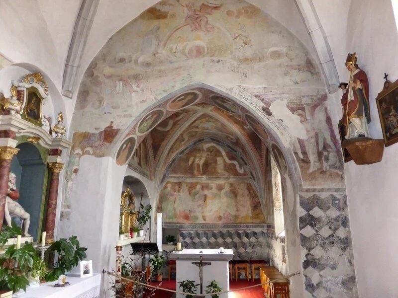 Interior of a small church with painted frescoes