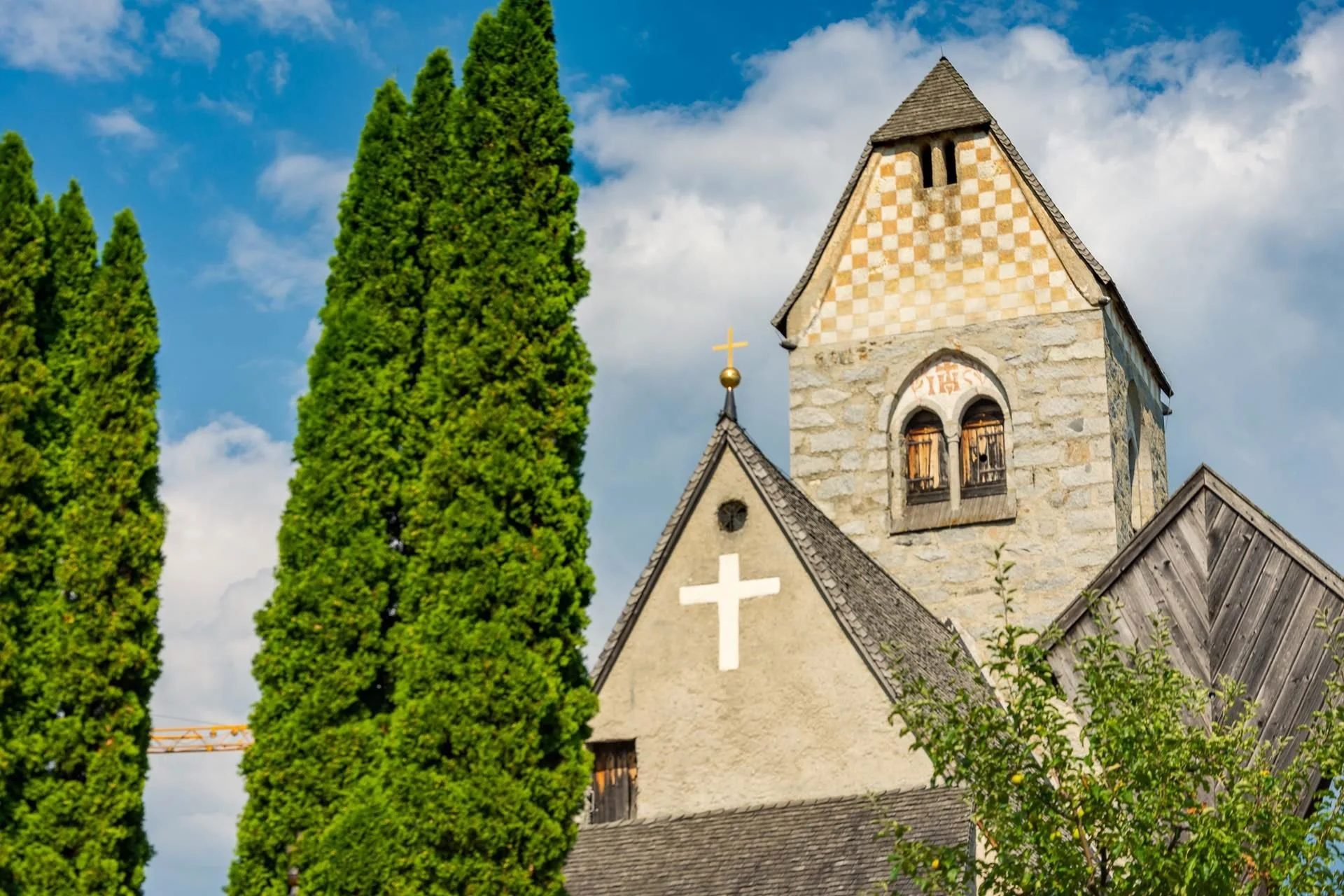A stone church with a cross on its gable